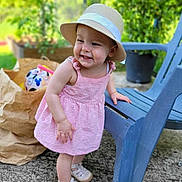 Amalya a rejoint le concours — aidez-le/la à gagner de superbes lots ! toddler, child, pink_dress, hat, smiling, outdoor, blue_chair, paper_bag, ball, greenery, concrete_floor, footwear, happy, playful, sun_hat, summer, baby, cute, daylight, portrait