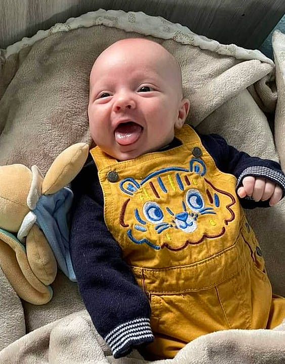 Tyméo participe au concours pour gagner de l'argent avec cette photo : baby, baby_laughing, baby_products, baby_toddler_clothing, bedding, cheek, child, comfort, facial_expression, grass, happy, laugh, linens, person, sitting, skin, sleeve, smile, t_shirt, textile