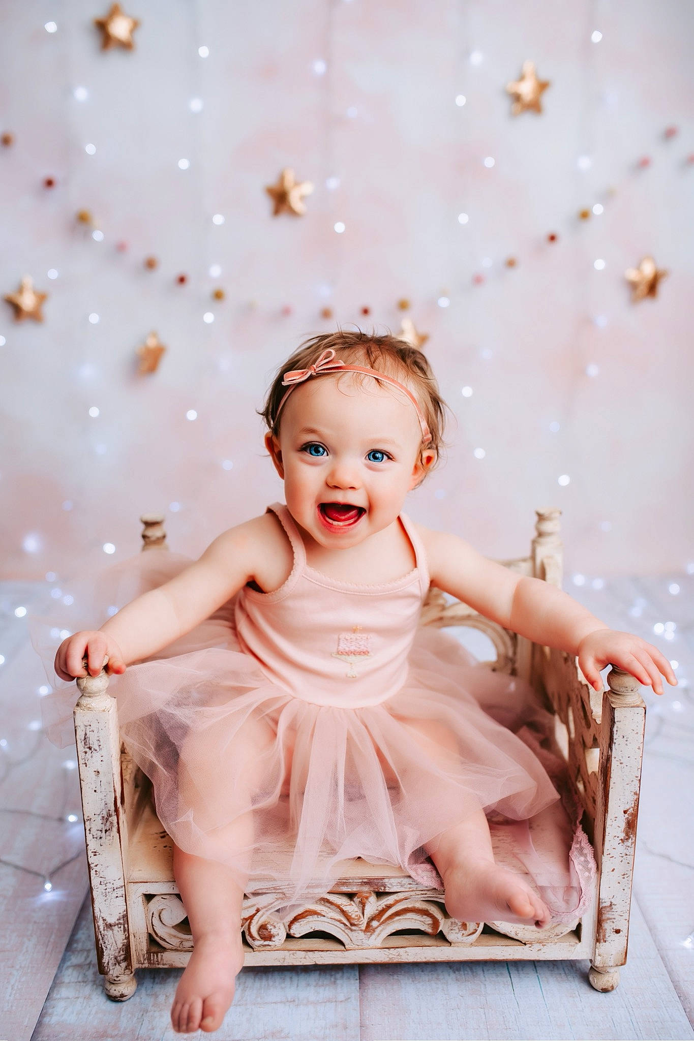 Lucie joined the competition — help win amazing prizes! baby, baby_toddler_clothing, bridal_accessory, chair, child, dress, fashion_accessory, flash_photography, fun, hair_accessory, happy, headband, headpiece, jewellery, peach, person, pink, sitting, skin, smile