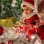 Eren a rejoint le concours — aidez-le/la à gagner de superbes lots ! accessories, baby, cap, christmas, christmasdecorations, clothing, costume, couch, face, festival, furniture, hat, head, lighting, ornament, person, photography, plant, portrait, tree