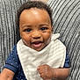 Carrick joined the competition — help win amazing prizes! baby, babylaughing, blackhair, chair, clothing, couch, cushion, face, furniture, happy, head, homedecor, jeans, laughing, pants, person, photography, portrait, sitting, smile