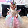 balloons, celebration, child, clothing, costume, cute, decoration, floor, happy, headband, indoor, party, pastel_colors, person, portrait, smiling, toddler, tutu, unicorn, wings