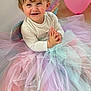 baby, celebration, child, clapping, costume, cute, fairy_wings, floor, fun, happy, indoor, joyful, long_sleeve_shirt, pastel_colors, pink_balloon, playing, portrait, smiling, toddler, tutu
