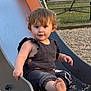 toddler, child, slide, playground, barefoot, curly_hair, outdoor, park, summer, smiling, clothing, metal_slide, grass, pebbles, fun, play, cute, person, young_child, daylight