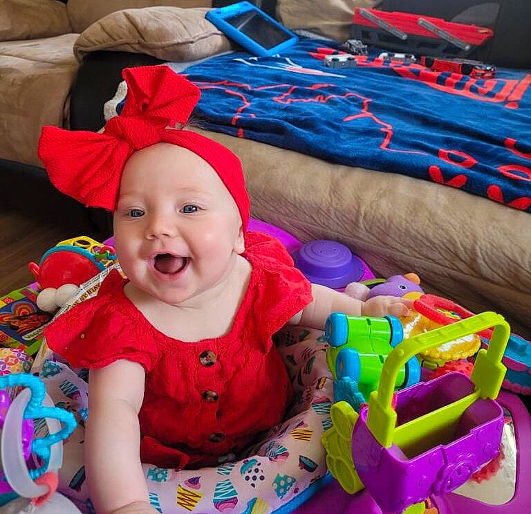 Skylar Grace is registered to the contest to win money with this photo: baby, baby_laughing, baby_playing_with_toys, baby_products, baby_toddler_clothing, baby_toys, blue, child, comfort, event, fun, happy, headwear, holiday, joy, person, play, product, sitting, smile