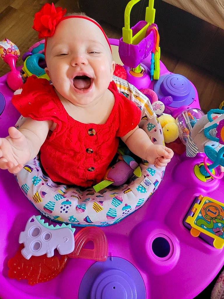 Skylar Grace is registered to the contest to win money with this photo: baby, baby_playing_with_toys, baby_products, baby_toddler_clothing, cheek, child, eye, facial_expression, fun, happy, headwear, magenta, organ, person, pink, purple, red, smile, snapshot, textile