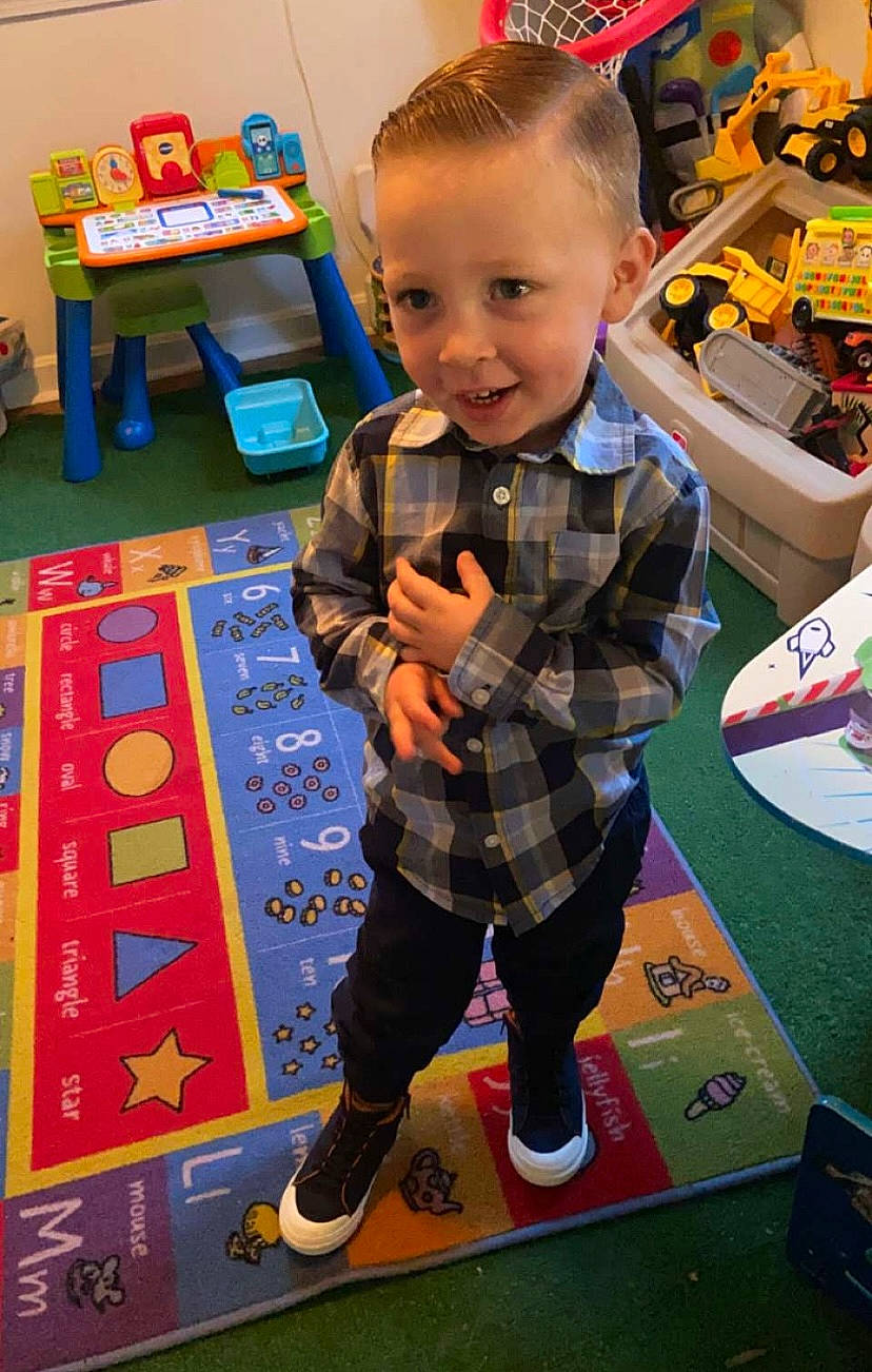 Julian joined the competition — help win amazing prizes! baby, box, carpet, child, event, flooring, fun, games, leisure, pattern, person, play, recreation, room, shoe, smile, tartan, toddler, toy, walking_shoe