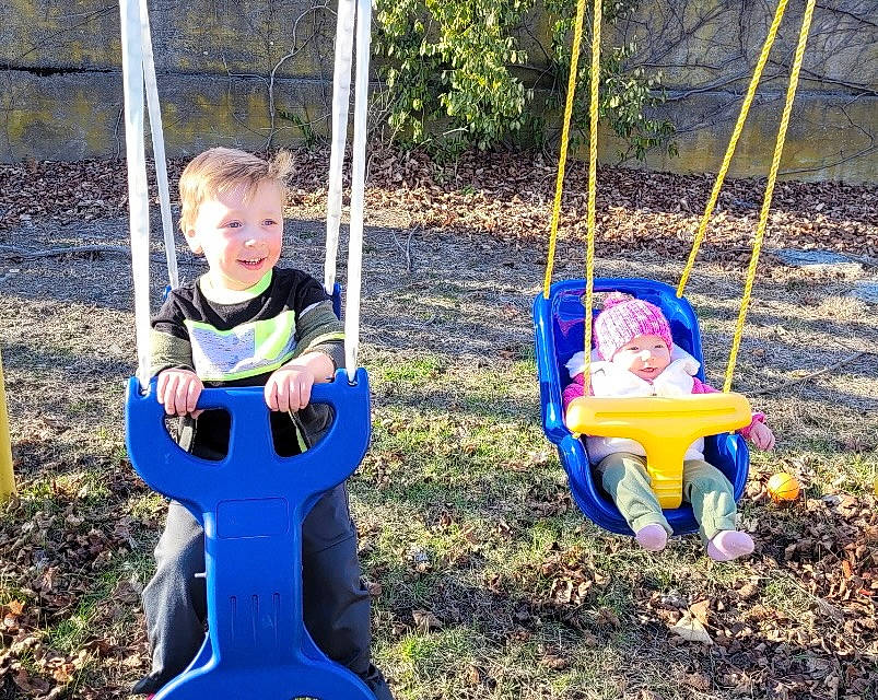 Julian is registered to the contest to win money with this photo: baby, baby_toddler_clothing, child, city, electric_blue, fun, grass, headwear, human_settlement, joy, leisure, outdoor_play_equipment, person, plant, play, playground, recreation, shade, sitting, swing