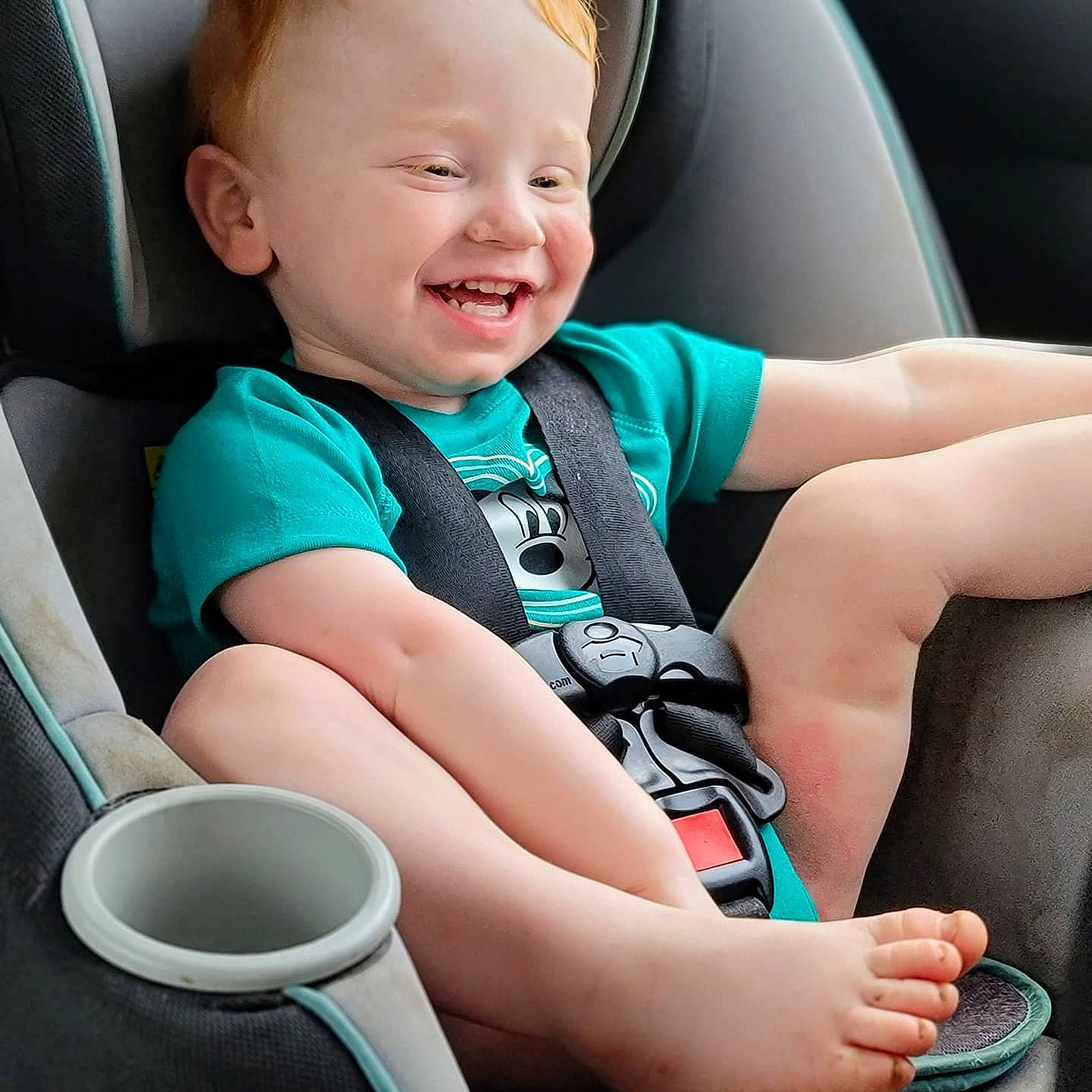 Carson is registered to the contest to win money with this photo: baby, baby_toddler_clothing, blue, car_seat, child, comfort, electric_blue, finger, happy, human_leg, knee, light, person, seat_belt, skin, smile, steering_wheel, thigh, thumb, toddler