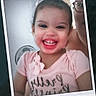 London is registered to the contest to win money with this photo: child, girl, smiling, portrait, indoor, pink_shirt, teeth, happy, sitting, close_up, instant_photo, polaroid, adult, glasses, photobomb, hair, face, shirt, home, date