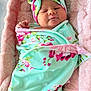 Iris joined the competition — help win amazing prizes! newborn, baby, infant, swaddle, blanket, headband, floral_pattern, pink, mint_green, cushion, soft_texture, sleepy, cute, child, portrait, indoors, wrapped, resting, peaceful, cozy