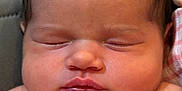 Iris is registered to the contest to win money with this photo: baby, newborn, sleeping, face, chubby_cheeks, skin, infant, close_up, portrait, soft_lighting, peaceful, wrapped, striped_cloth, cute, child, human, young, head, eyelashes, lips