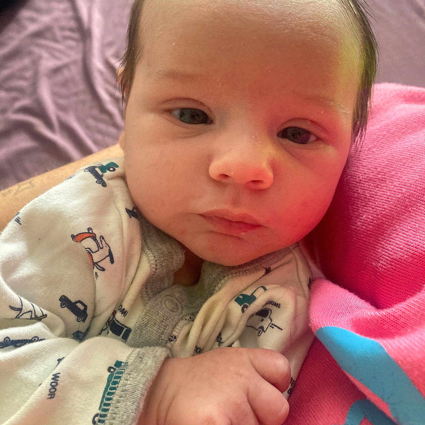 Rhydian is registered to the contest to win money with this photo: adorable, baby, bed, blanket, close_up, eyes, face, family_moment, hair, hand, infant, newborn, onesie, patterned_clothing, pink, portrait, skin, sleepy, small_fingers, soft_light