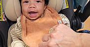 Kashius is registered to the contest to win money with this photo: baby, baby_toys, bib, blanket, car_seat, child, clothing, cozy, curly_hair, cute, hand, happy, indoor, infant, pacifier, person, portrait, seatbelt, smiling, toddler