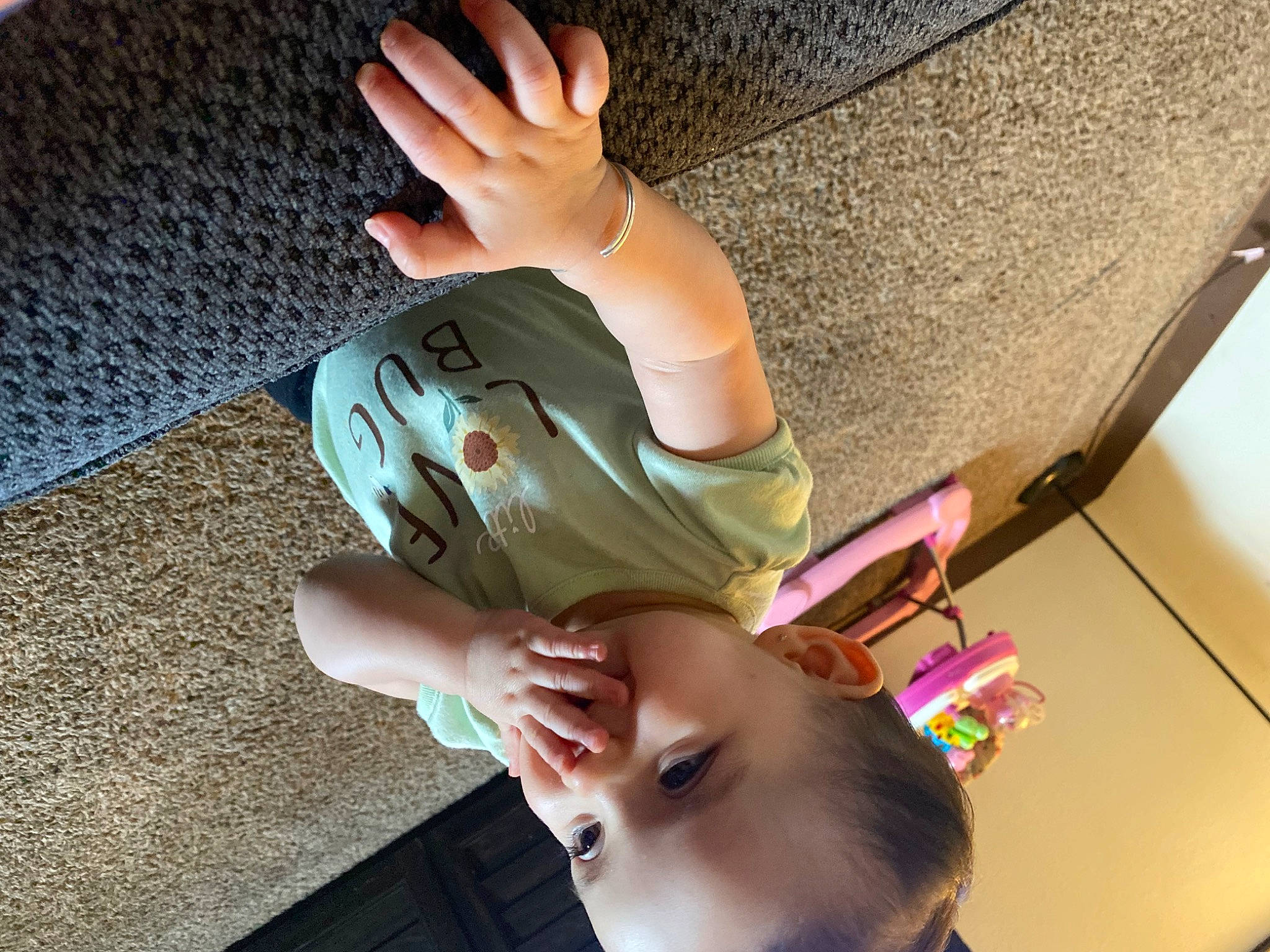Armani is registered to the contest to win money with this photo: baby, child, comfort, elbow, finger, flooring, foot, fun, gesture, hand, happy, human_leg, knee, nail, person, play, thigh, thumb, toddler, wood