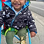 Jahqaari is registered to the contest to win money with this photo: baby, black_shoes, casual, child, closeup, daylight, green_pants, happy, jacket, leaf, outdoor, person, playful, seatbelt, smiling, space_pattern, stroller, toddler, twig, urban