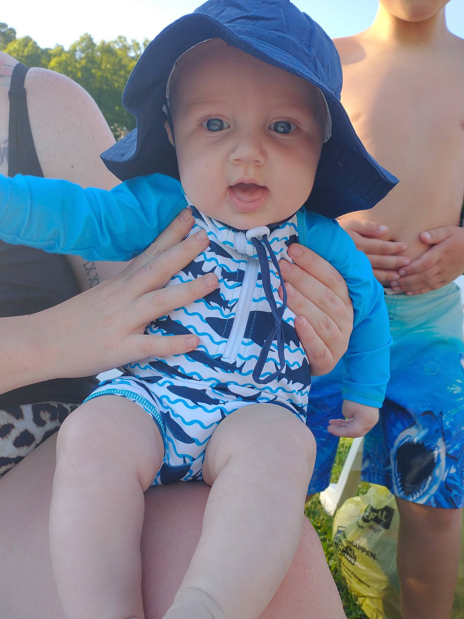 Kolby is registered to the contest to win money with this photo: azure, baby, baby_toddler_clothing, blue, cap, child, cool, finger, grass, happy, headgear, headwear, leg, leisure, organ, person, photograph, shoulder, skin, sun_hat