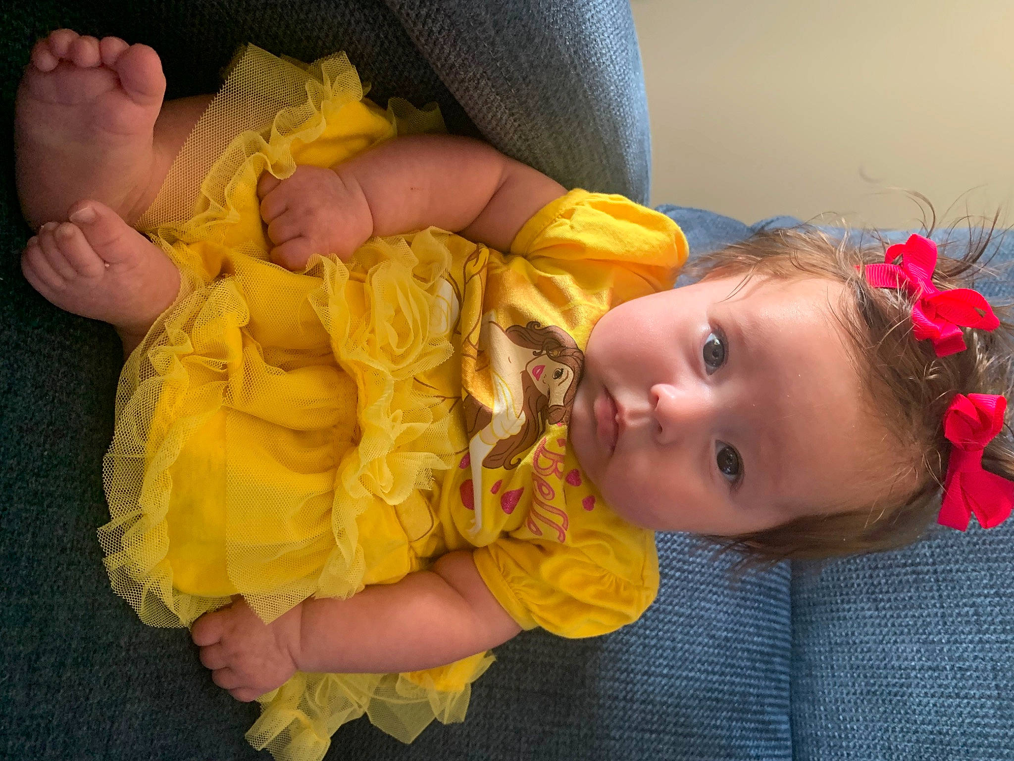 Giovanna is registered to the contest to win money with this photo: arm, baby, baby_toddler_clothing, cheek, eye, facial_expression, finger, gesture, hairstyle, hand, head, human_body, iris, mouth, nose, orange, person, pink, skin, textile