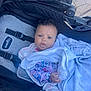baby, infant, stroller, blanket, blue_eyes, curly_hair, clothing, mickey_mouse, minnie_mouse, child, outdoor, seatbelt, fabric, comfort, cute, person, portrait, wrapped, toddler, soft