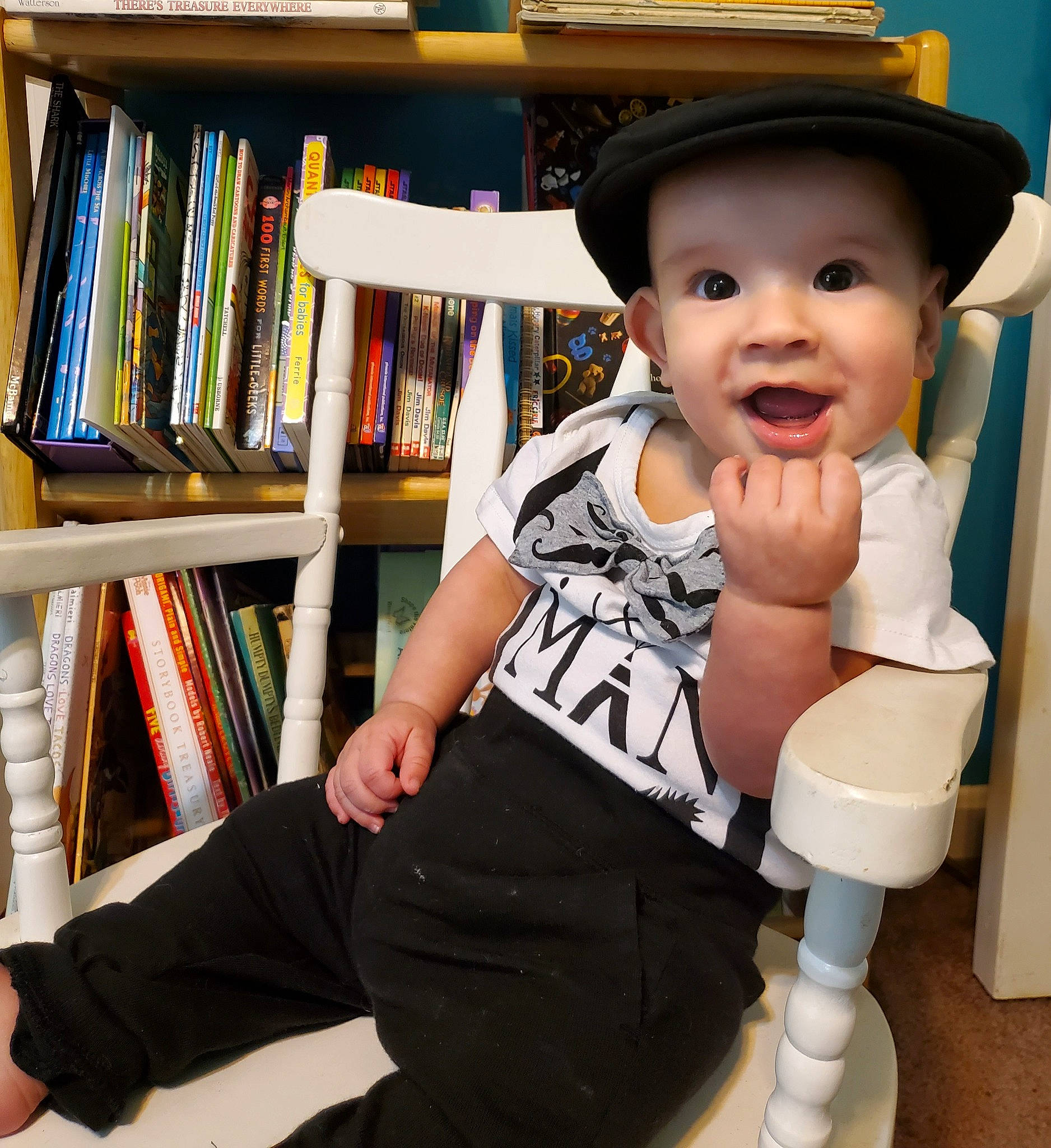Arthur joined the competition — help win amazing prizes! baby, book, bookcase, cool, happy, hat, headwear, human_body, human_leg, knee, person, publication, shelf, shelving, sitting, sleeve, sock, sun_hat, thigh, thumb