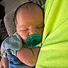 newborn, baby, pacifier, sleeping, infant, hand, mittens, blue_clothing, green_fabric, close_up, person, cute, resting, toddler, indoor, soft_light, peaceful, portrait, skin, head