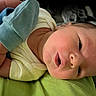 Weston joined the competition — help win amazing prizes! newborn, baby, infant, face, skin, clothing, mittens, yellow, blue, green, closeup, portrait, sleepwear, person, cute, small, soft, lying, indoors, head