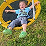 Theodore is registered to the contest to win money with this photo: child, smiling, swing, outdoor, grass, greenery, playground, happy, casual_clothing, toddler, yellow_swing, green_shoes, shorts, blue_tshirt, sunny, nature, fun, leisure, relaxing, play