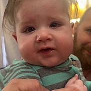 Kallum joined the competition — help win amazing prizes! adult, baby, background_blur, beard, child, closeup, curious, cute, face, hand, holding, human, indoor, infant, person, portrait, smile, striped_clothing, warm_lighting, young_child