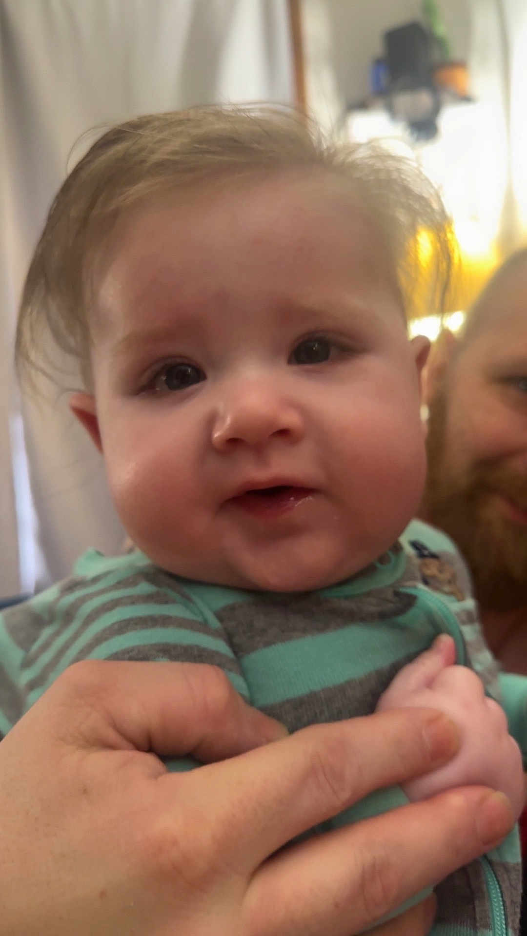 Kallum joined the competition — help win amazing prizes! adult, baby, background_blur, beard, child, closeup, curious, cute, face, hand, holding, human, indoor, infant, person, portrait, smile, striped_clothing, warm_lighting, young_child