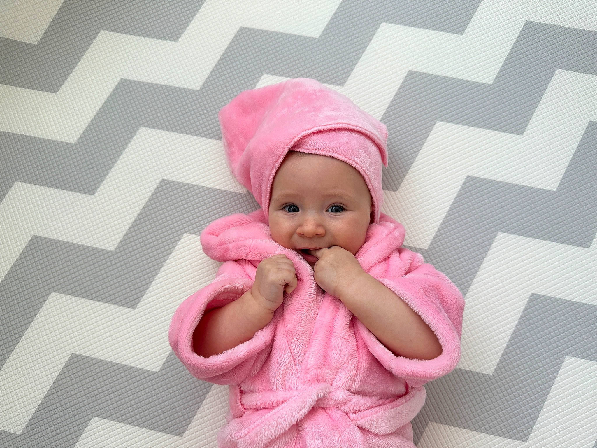 Emily joined the competition — help win amazing prizes! baby, baby_toddler_clothing, beanie, cap, child, comfort, fashion_accessory, gesture, happy, headgear, headwear, knit_cap, linens, magenta, pattern, person, pink, sleeve, textile, thumb