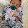 baby, sleeping, pacifier, bib, striped_pajamas, blue_slippers, blanket, cozy, cute, infant, child, resting, soft, comfort, indoor, portrait, closeup, peaceful, face, hand