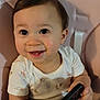 baby, child, smiling, pigtails, high_chair, phone, smartphone, white_shirt, indoor, cute, happy, portrait, infant, person, hand, face, seated, looking_up, young, playful