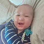 Taylor participe au concours pour gagner de l'argent avec cette photo : baby, smiling, blanket, pacifier, striped_clothing, couch, cushion, infant, happy, hands, face, indoors, closeup, child, cute, comfort, soft_toys, relaxed, person, portrait