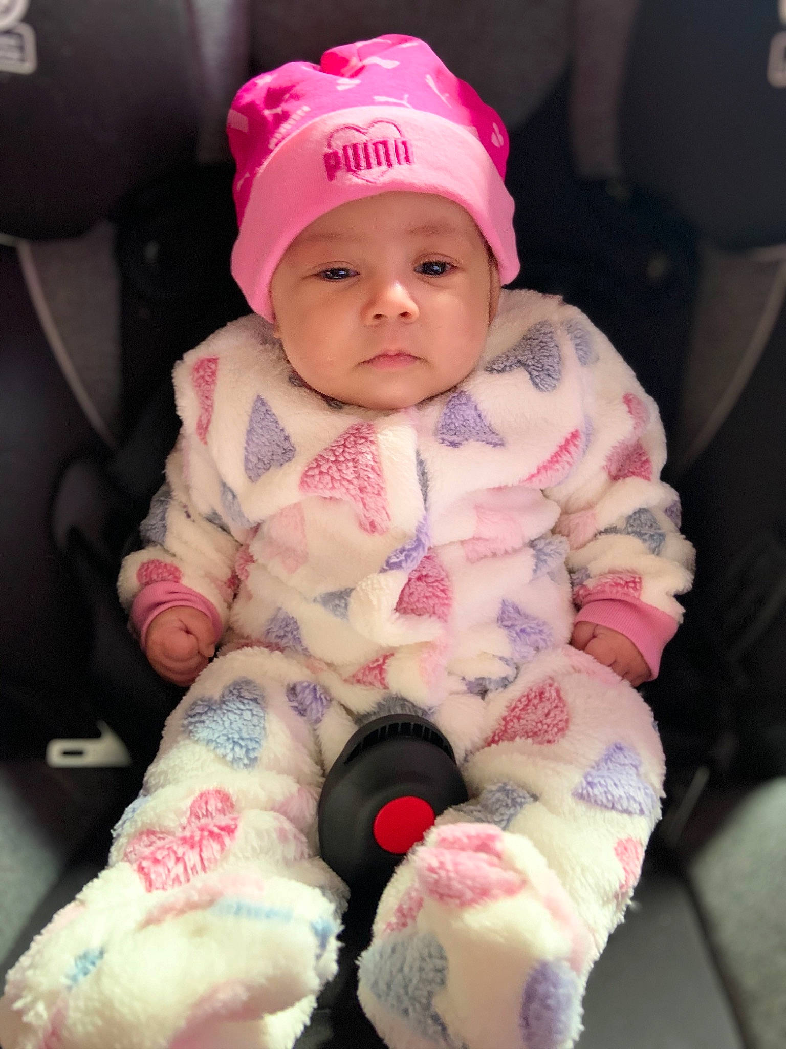 Aubrielle is registered to the contest to win money with this photo: baby, baby_products, baby_toddler_clothing, cap, car_seat, carmine, cheek, child, comfort, face, headwear, human_body, lip, magenta, pattern, person, pink, sitting, skin, sleeve