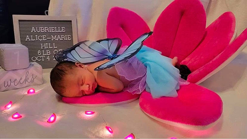 Aubrielle is registered to the contest to win money with this photo: baby, baby_products, baby_sleeping, baby_toddler_clothing, cap, child, comfort, finger, font, fun, happy, headpiece, linens, magenta, person, petal, pink, purple, textile, toddler