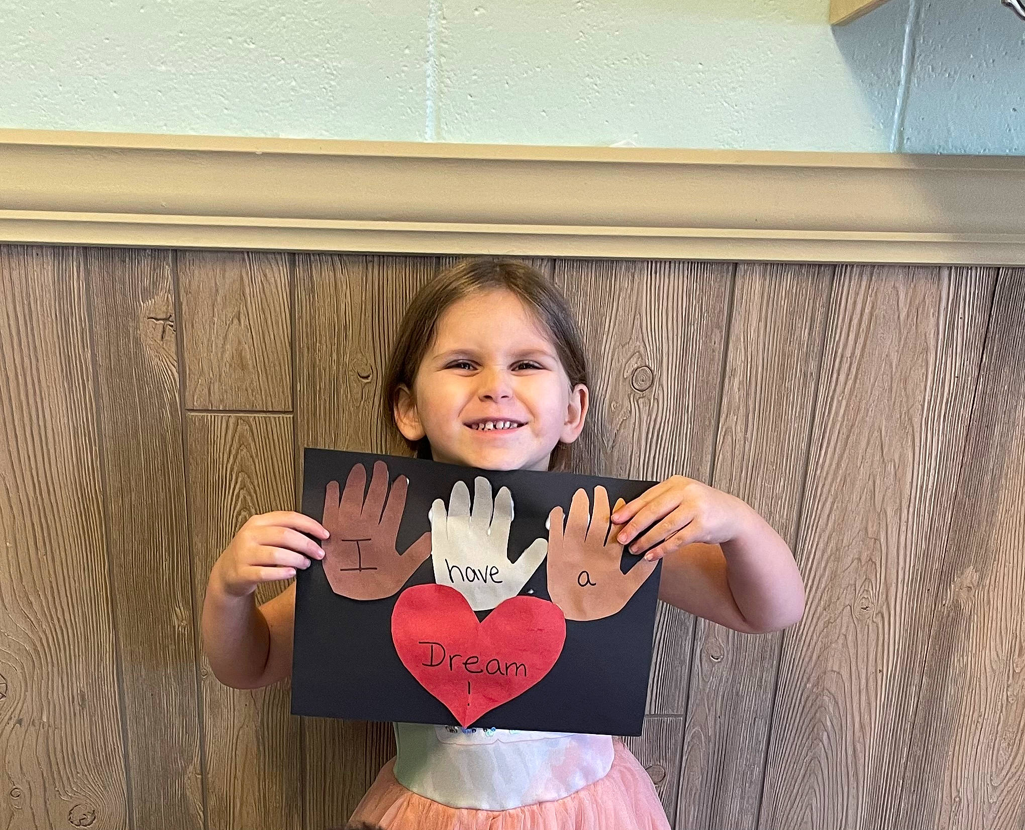 Scarlett is registered to the contest to win money with this photo: abdomen, baby_toddler_clothing, child, dress, eye, finger, fun, gesture, hair, happy, head, human_body, joy, magenta, person, pink, sleeve, smile, toddler, trunk