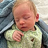 Maximillian is registered to the contest to win money with this photo: baby, sleeping, blanket, onesie, green_clothing, bunny_pattern, hand, face, infant, cozy, soft_texture, peaceful, nap, bed, human, child, cute, portrait, relaxation, newborn