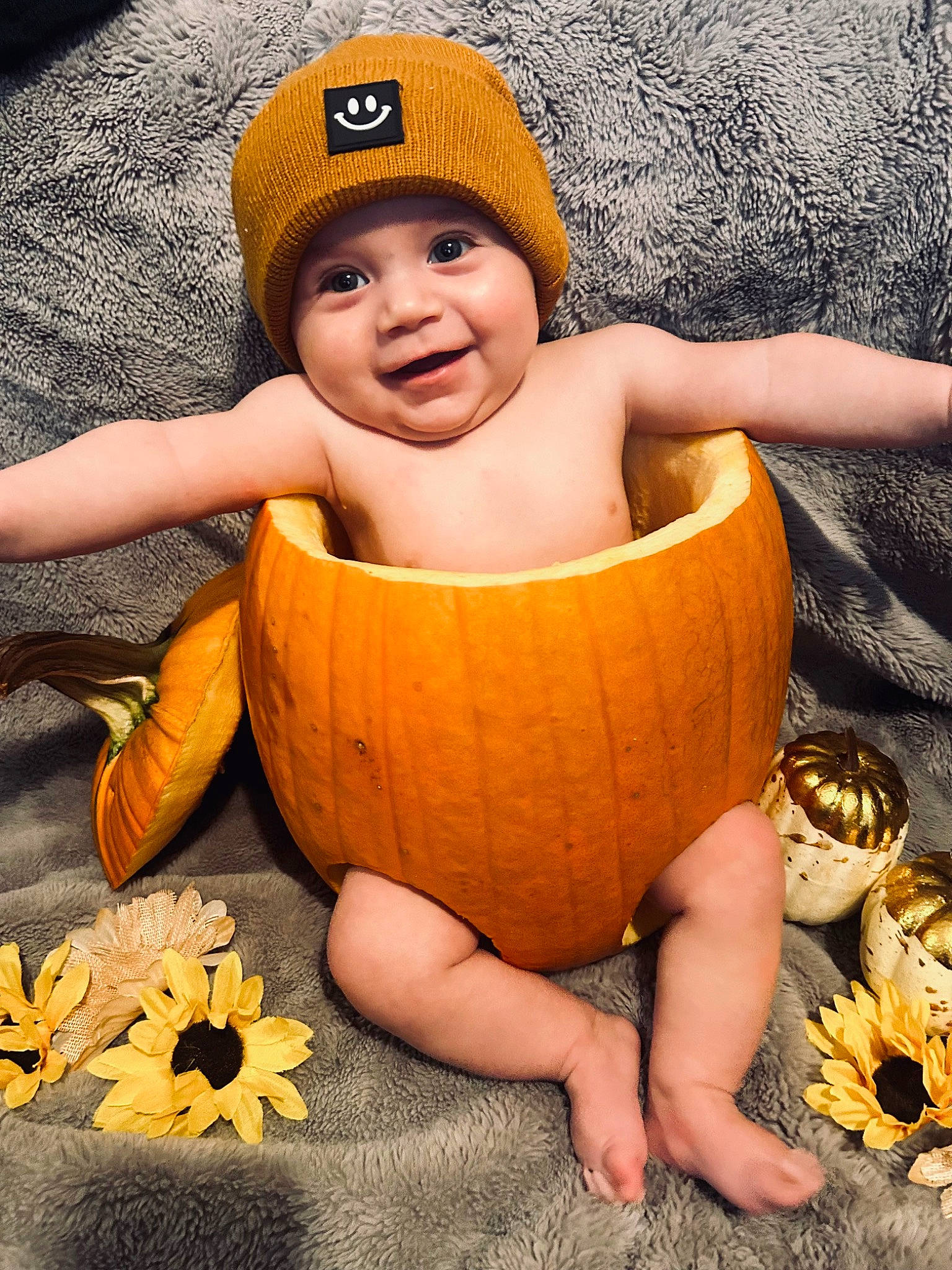 Ethan joined the competition — help win amazing prizes! baby, baby_toddler_clothing, cap, dress, eye, face, facial_expression, finger, hand, happy, head, headgear, headwear, human_body, joy, leaf, orange, person, photograph, plant