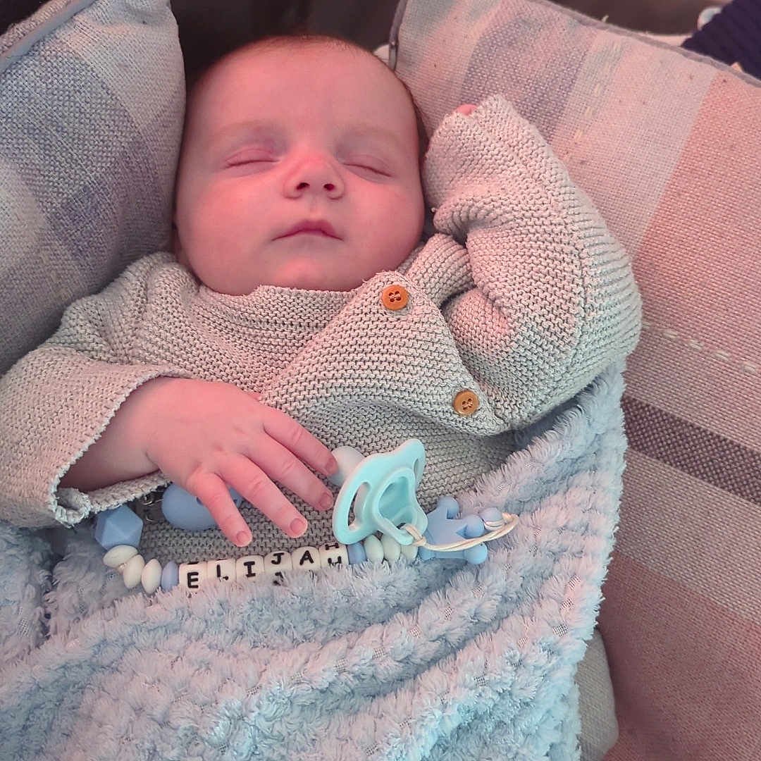 Elijah joined the competition — help win amazing prizes! baby, bed, blanket, bodypart, couch, cushion, face, finger, furniture, hand, head, homedecor, linen, newborn, person, photography, portrait, quilt, sleeping, towel