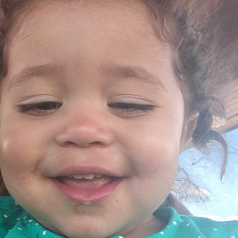 Xariah is registered to the contest to win money with this photo: buttoned_shirt, casual_clothing, child, close_up, curly_hair, cute, daylight, face, green_shirt, happy, indoors, natural_light, polka_dot, portrait, selfie, sky, smile, toddler, wooden_ceiling, young_child