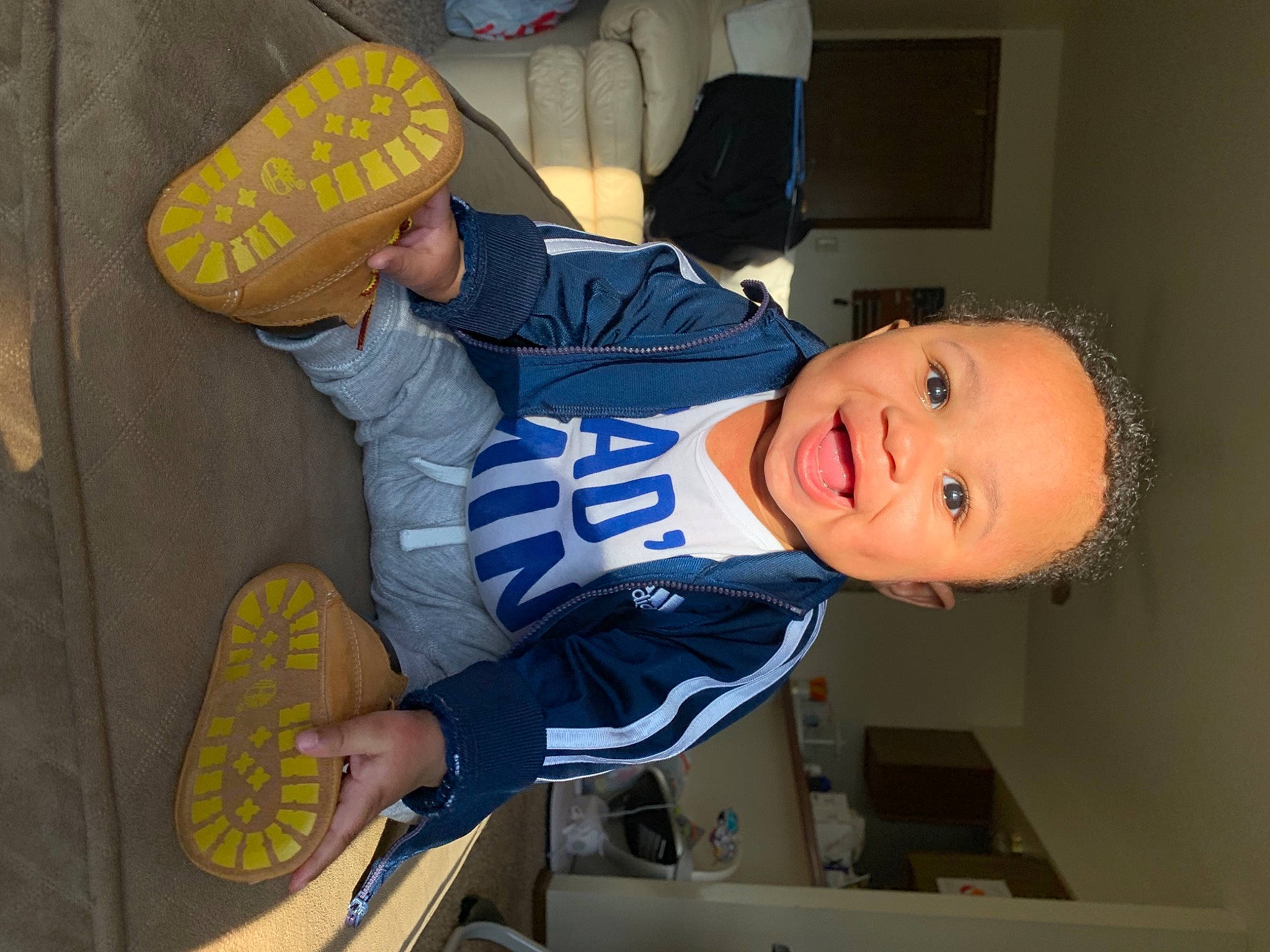 Brison is registered to the contest to win money with this photo: baby_toddler_clothing, child, elbow, electric_blue, fun, happy, hat, person, room, sleeve, smile, sportswear, t_shirt, toddler, uniform, yellow