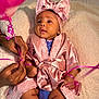 Zaina joined the competition — help win amazing prizes! baby, infant, pink_bow, silk_robe, ribbons, hands, blanket, closeup, cute, child, portrait, soft_texture, skin, indoor, newborn, adorable, fashion, headwear, sitting, person