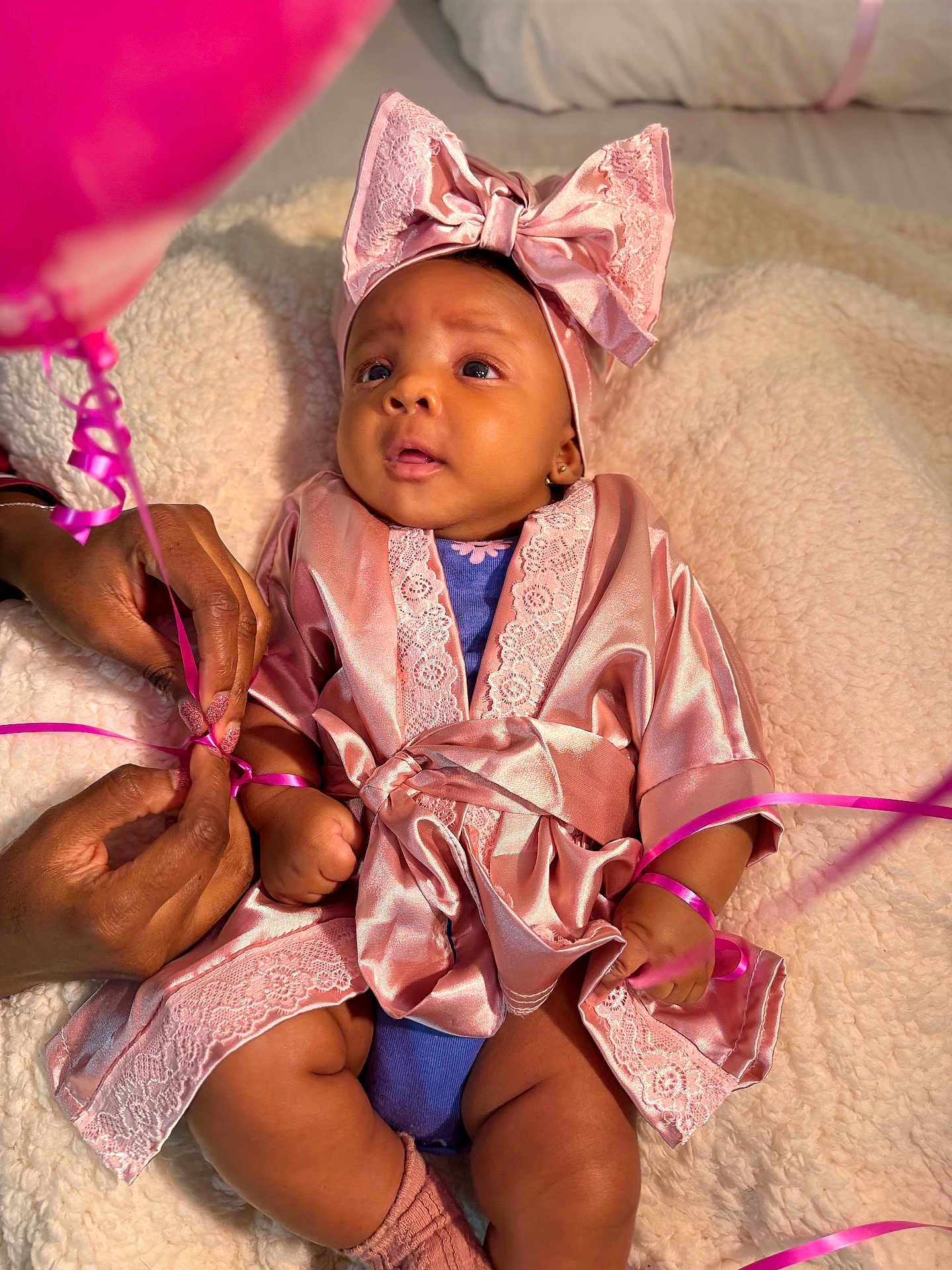 Zaina joined the competition — help win amazing prizes! baby, infant, pink_bow, silk_robe, ribbons, hands, blanket, closeup, cute, child, portrait, soft_texture, skin, indoor, newborn, adorable, fashion, headwear, sitting, person