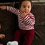 Ulysse participe au concours pour gagner de l'argent avec cette photo : toddler, child, striped_shirt, red_pants, white_socks, couch, indoor, curly_hair, hand_on_couch, finger_in_mouth, staircase, brown_furniture, expression, portrait, sitting, young_child, casual_clothing, home_interior, curious, face