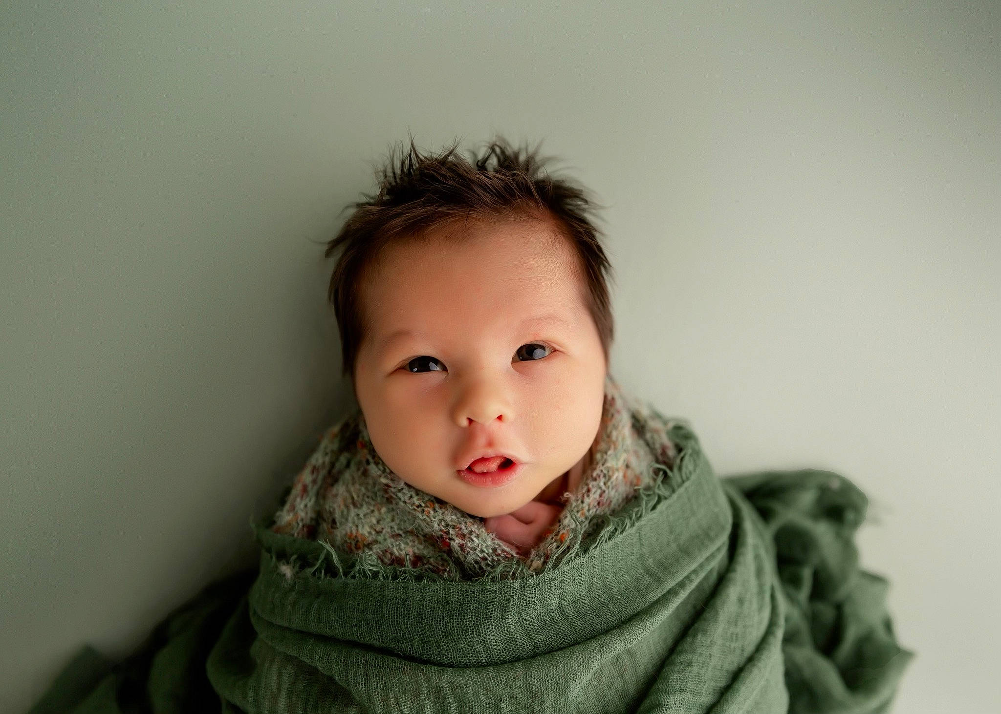 Ezra is registered to the contest to win money with this photo: baby, black_hair, cheek, child, collar, comfort, eyelash, flash_photography, fur, happy, iris, jaw, lip, neck, nose, person, sitting, sleeve, toddler, wool