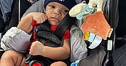 Joshua is registered to the contest to win money with this photo: accessory, baby, baby_toy, blanket, car, car_seat, child, clothing, cute, hat, indoor, infant, person, portrait, puma, seat, seatbelt, sitting, socks, toy