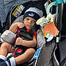 accessory, baby, baby_toy, blanket, car, car_seat, child, clothing, cute, hat, indoor, infant, person, portrait, puma, seat, seatbelt, sitting, socks, toy