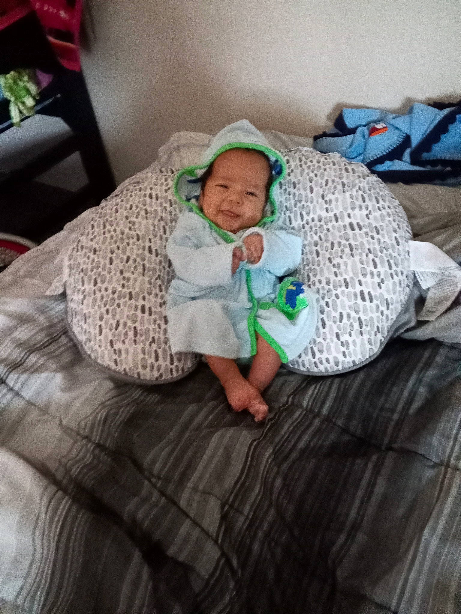 Richard is registered to the contest to win money with this photo: baby, baby_toddler_clothing, child, comfort, couch, flooring, foot, grass, hand, hardwood, hat, human_body, linens, person, room, sitting, skin, textile, thigh, toddler