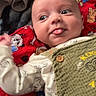 Nashtyn joined the competition — help win amazing prizes! baby, infant, tongue_out, blanket, cartoon_dogs, green_outfit, wooden_buttons, face, expression, lying_down, hand, curious, cute, indoors, technology, laptop, red_blanket, playful, child, person