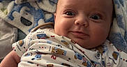 Nashtyn joined the competition — help win amazing prizes! baby, infant, onesie, blanket, bed, smile, face, expression, diaper, human, child, cute, skin, indoor, relax, comfort, person, clothing, happy, portrait